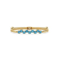 Nine princess-cut aquamarine colorstones in a yellow gold chain-accent cuff bracelet
