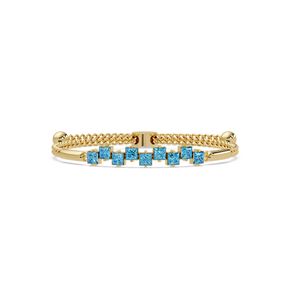 Nine princess-cut aquamarine colorstones in a yellow gold chain-accent cuff bracelet