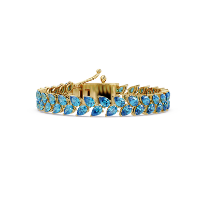 Pear-cut aquamarine colorstone tennis bracelet in yellow gold