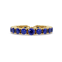 Round sapphire blue colorstone bangle in yellow gold
