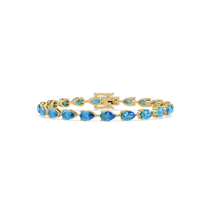 Pear-cut aquamarine blue colorstone tennis bracelet in yellow gold