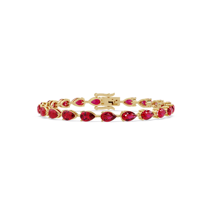 Pear-cut ruby red colorstone tennis bracelet in yellow gold