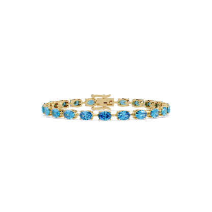 Oval-cut aquamarine blue colorstone tennis bracelet in yellow gold
