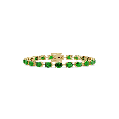 Oval-cut emerald green colorstone tennis bracelet in yellow gold