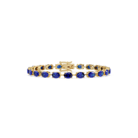 Oval-cut sapphire blue colorstone tennis bracelet in yellow gold