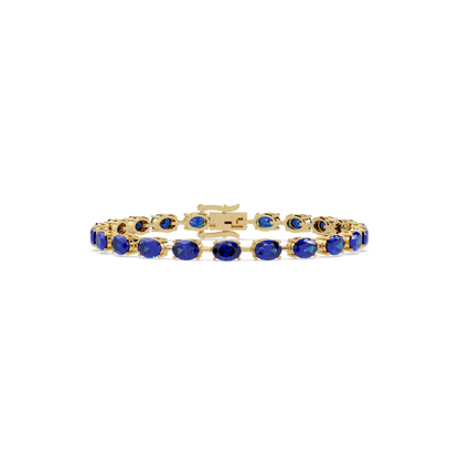 Oval-cut sapphire blue colorstone tennis bracelet in yellow gold