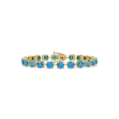 Round aquamarine blue colorstone tennis bracelet in yellow gold