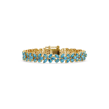 Mixed-shape aquamarine blue colorstone tennis bracelet in yellow gold