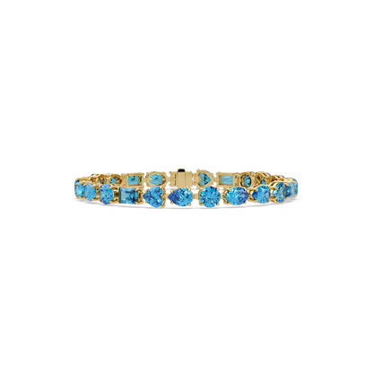 Mixed-shape aquamarine blue colorstone tennis bracelet in yellow gold
