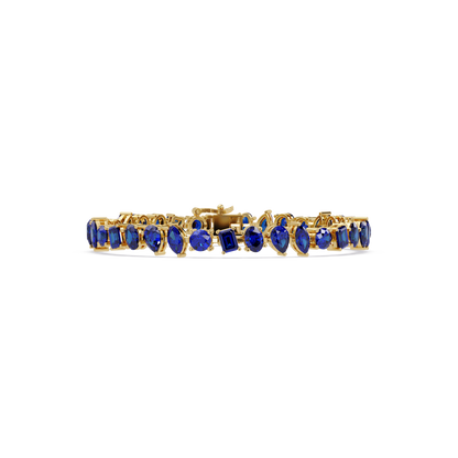 Oval, emerald, marquise, pear and round sapphire blue colorstone tennis bracelet in yellow gold
