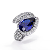 3.0 CTW pear-cut halo pavé bypass colorstone ring product render with round pavé accent stones.
