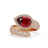 3.0 CTW pear-cut Ruby Red halo pavé bypass ring in 14K Rose Gold with round pavé accent stones.
