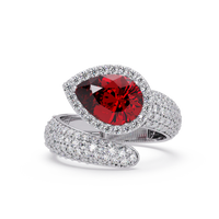 3.0 CTW pear-cut Ruby Red halo pavé bypass ring in 14K White Gold with round pavé accent stones.