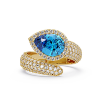 3.0 CTW pear-cut Aquamarine Blue halo pavé bypass ring in 14K Yellow Gold with round pavé accent stones.