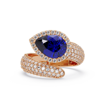 3.0 CTW pear-cut Sapphire Blue halo pavé bypass ring in 14K Rose Gold with round pavé accent stones.