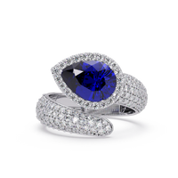 3.0 CTW pear-cut Sapphire Blue halo pavé bypass ring in 14K White Gold with round pavé accent stones.